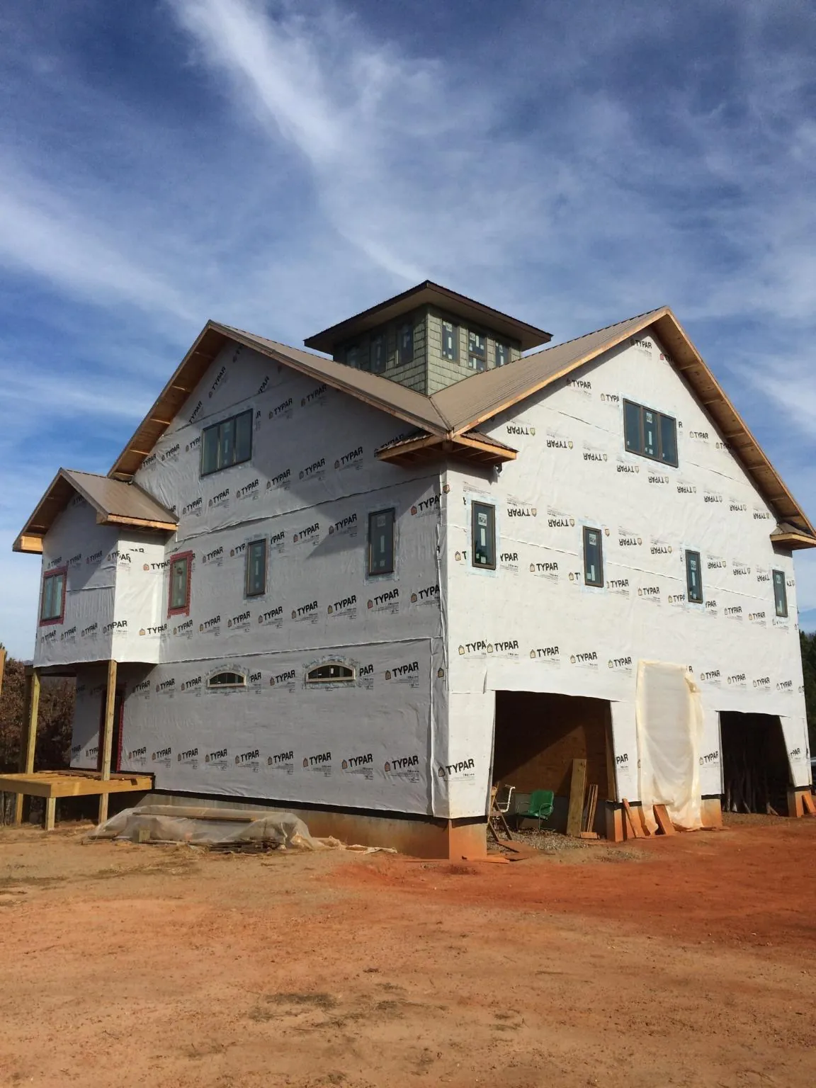 New two story house under construction with a cupola and gabled roofs in Eskridge